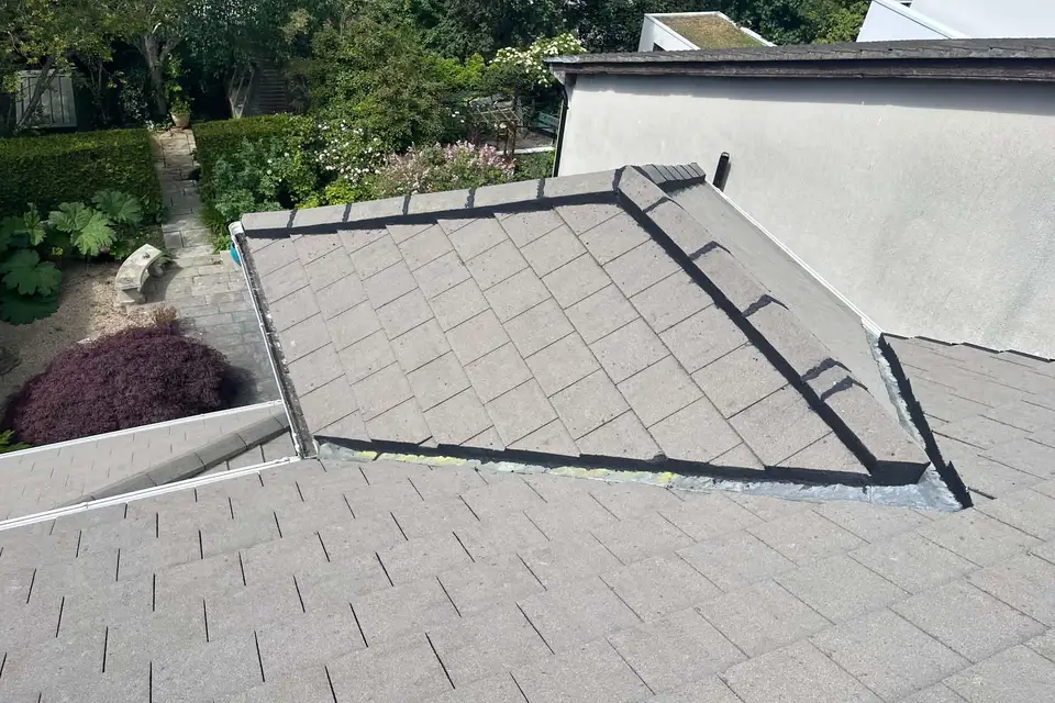 Tiled extension roof finished against the house wall
