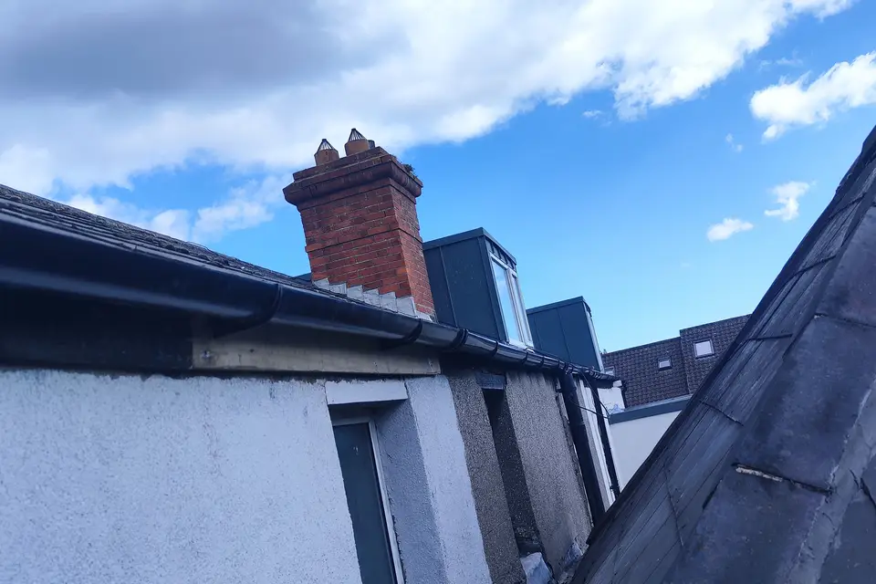Black fascia and gutter on a rendered house