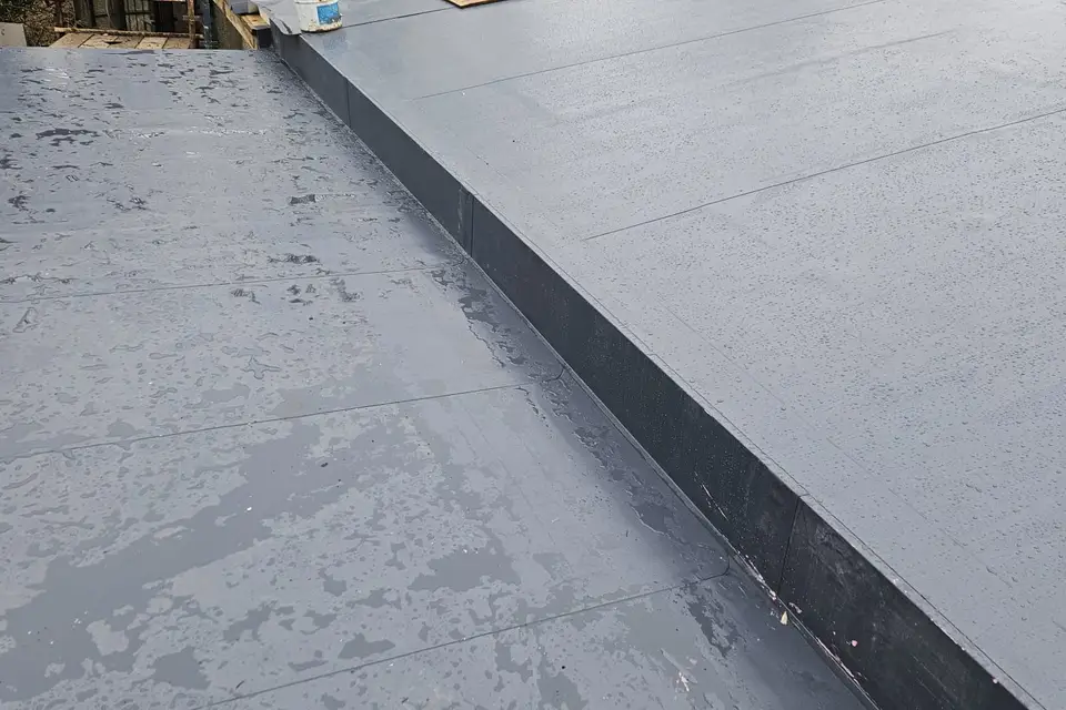 New flat roof membrane with a raised edge detail