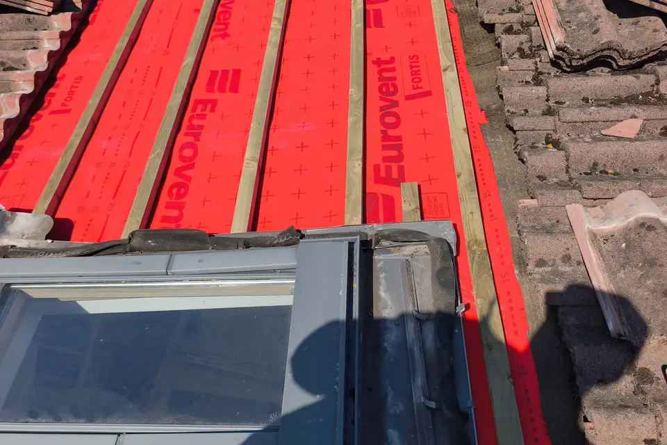 New membrane and battens fitted around a roof window during re-roofing