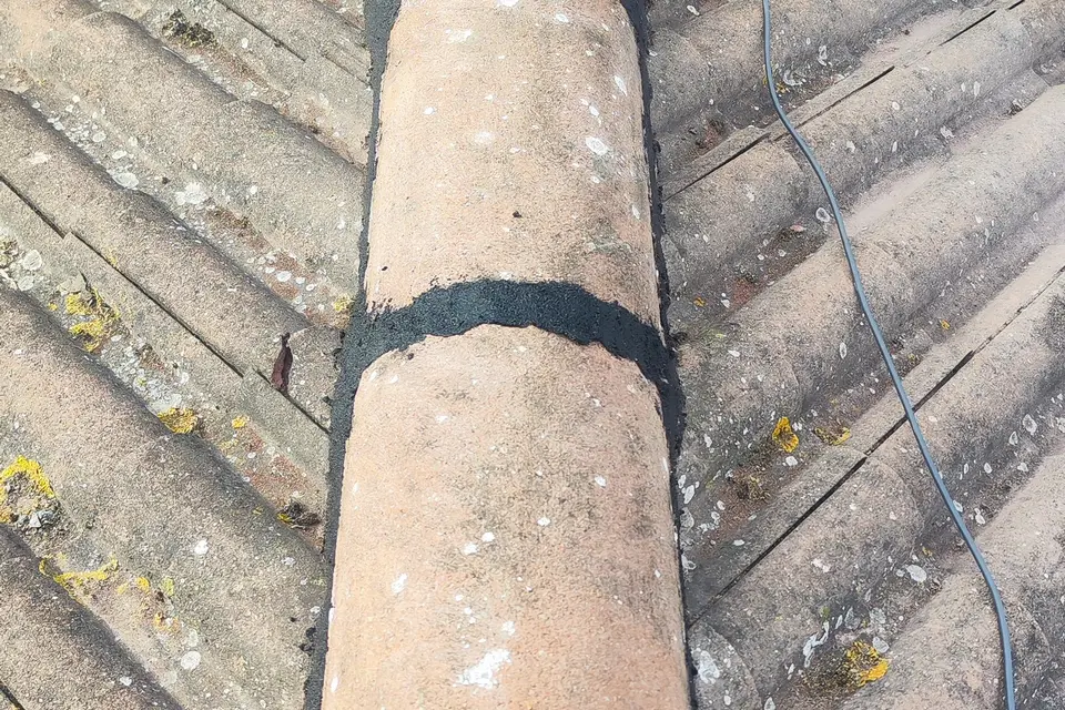 Ridge tiles re-bedded and pointed on a concrete tile roof