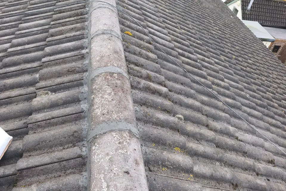 Ridge line on a tiled roof after repair