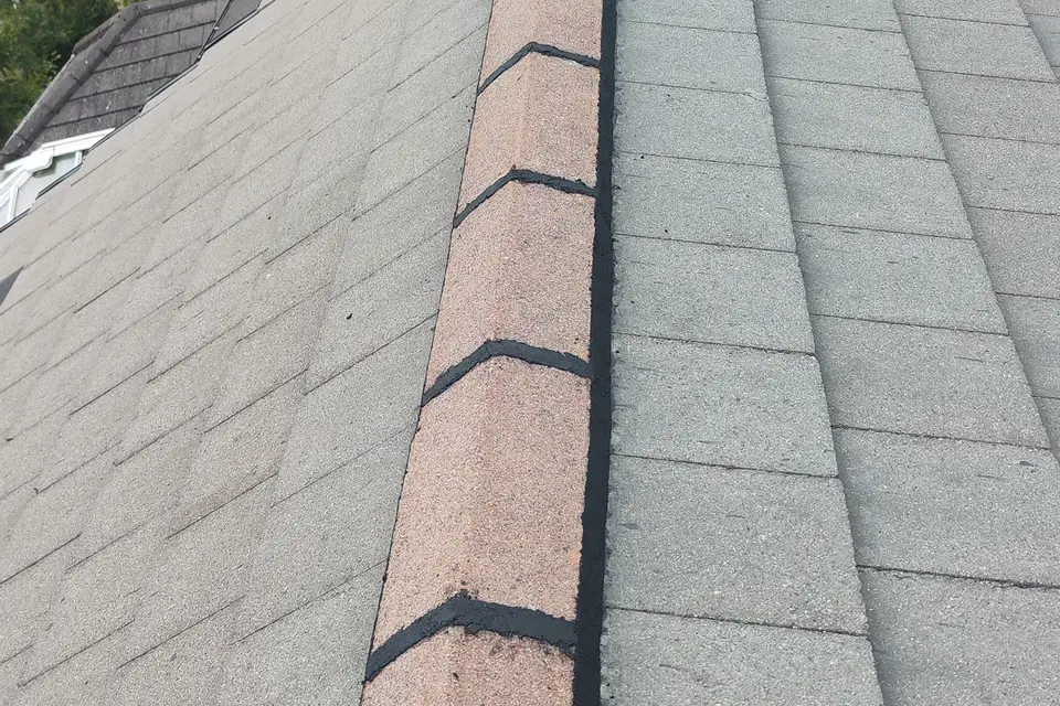 Finished ridge tiles on a concrete tile roof