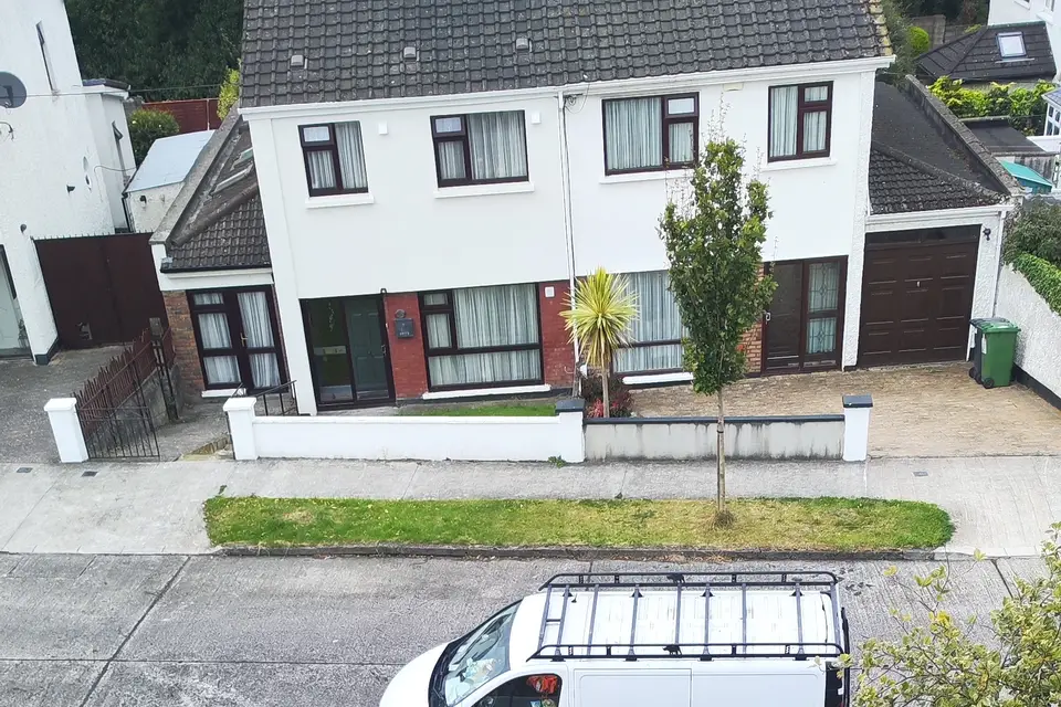 Looking down from a roof on a job to the street below, with a white van parked outside