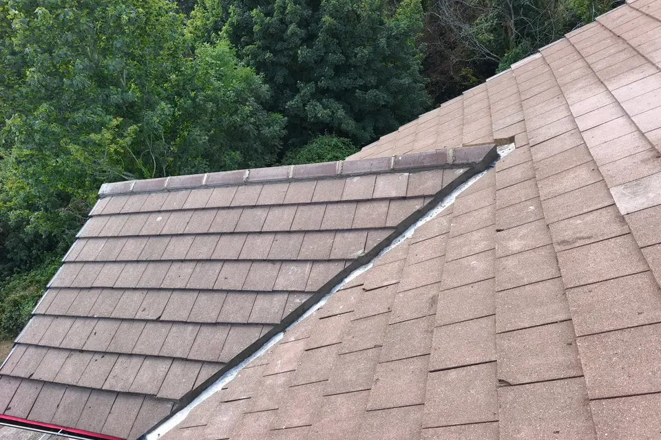 Finished roof valley between two tiled slopes